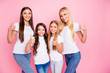 © deagreez - Photo of four different age ladies hugging raising thumbs up wear casual outfit isolated pink background