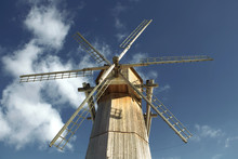 Old Wooden Windmill Against A Blue Sky In Sunny Day Close-up