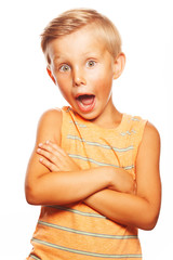 Wall Mural - Oh, my God, Can't believe it, School Gossip concept. Portrait of shocked cute little boy in orange sleeveless T-shirt isolated on white background. Close up. Hands crossed. Studio shot