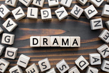 Drama - Word From Wooden Blocks With Letters, Literary Genres Concept, Random Letters Around, Top View On Wooden Background