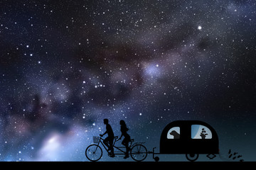 Sticker - Newlyweds on bike tandem on road at night. Vector illustration with silhouettes of people and dog traveling with camper trailer. Family road trip. Space dark background with starry sky and Milky Way