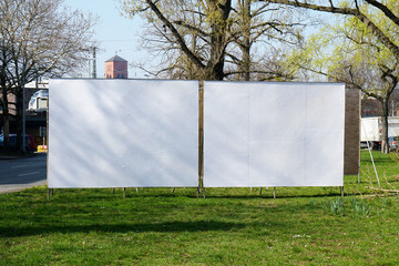 Wall Mural - two realistic empty billboards side by side on urban roadside greenery