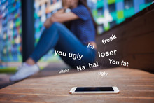 A Smartphone Lying In The Foreground, Blurred Background, Girl, Crying, Covering Face While Sitting On A Wooden Bench.