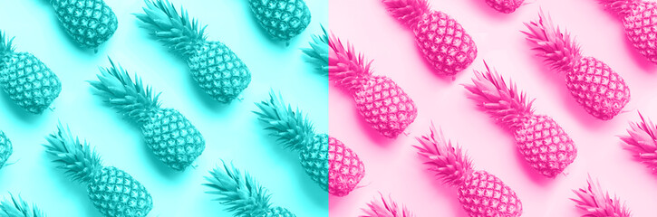 Wall Mural - fresh pineapples on trendy neon pink and blue color background. top view. pop art design, creative c