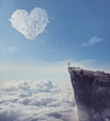 © psychoshadow - Imaginary view with a boy on the edge of a cliff, trying to catch a heart shaped cloud with a long rope. Follow your heart concept.