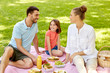 © Syda Productions - family, leisure and people concept - happy mother, father and daughter having picnic at summer park