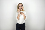 Fototapeta Konie - young beautiful blonde business woman in eyeglasses recieved good news from business partner during important phone negotiations isolated white background