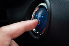 Hand Push On Car Engine Power Start Button Close Up