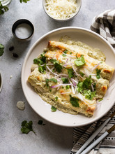 Cheesy Enchiladas Filled With Chredded Chicken And Black Beans, Served With  Creamy Sauce