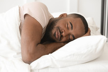 Serene Calm Young Black Man Sleeping Well Alone In Bed
