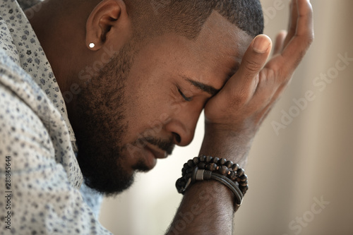 Cuadros en Lienzo Upset stressed young african american man coping with strong headache