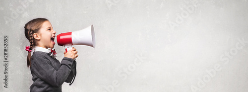 Fotografía Child Girl Student Shouting Through Megaphone on Grey Backdrop w