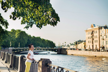 A beautiful tourist of Mature age admires the views of the city of St. Petersburg