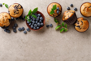 Wall Mural - Blueberry muffins with fresh berries, top view