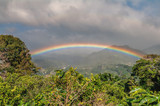 Fototapeta Tęcza - Vibrant rainbow tropical rainy sky Panama
