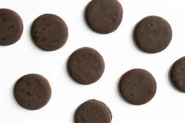 Wall Mural - Group of thin mints cookies on white background, chocolate mint thin round cookies, top view