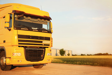 Wall Mural - Modern yellow truck on country road. Space for text