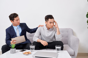 Wall Mural - Listen to me. Asian man wrinkling forehead while looking at his therapist