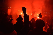 Protesters Photographed During A Night Demonstration With Red Flash Lights
