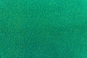 Green paper background. Empty space concept. Green paper texture background. Brilliant shiny backdrop from textile. Shimmer denim paper