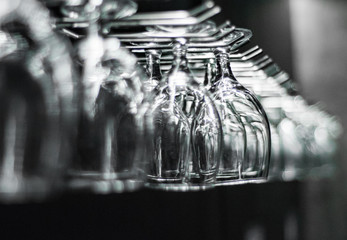 Empty glasses for wine above a bar rack