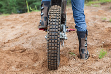 Motorcycle Rider Has A Ride In Sand Pit, Rear View Of Bike Tire And Men Boots