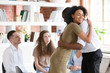 Woman psychologist addiction counsellor hugging supporting guy at group session