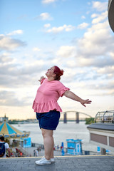 Young fat woman walking in the city