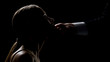 © motortion - Cruel man holding and looking at beautiful face of young lady, human trafficking