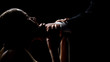 © motortion - Angry man holding womans face, submission and humiliation, dark background