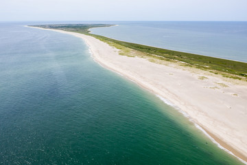 The cold waters of the Atlantic Ocean bathe a scenic beach on Cape Cod, Massachusetts. This beautiful area of New England, not too far from Boston, is a popular summer vacation destination.