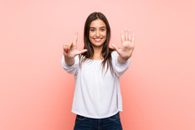 Young Woman Over Isolated Pink Background Counting Seven With Fingers