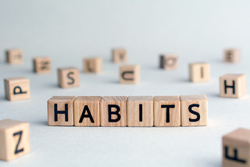 Wall Mural - habits - word from wooden blocks with letters, Regular tendency or practice Routine, regularly acts concept, random letters around, top view on wooden background