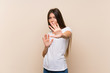 © luismolinero - Pretty young girl over isolated background nervous stretching hands to the front