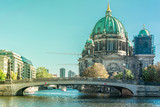 Fototapeta Miasto - Beautiful overview of the old Friedrichs Brigde above the Spree river and next to the Berliner Dom, the Cathedral of Berlin under reform, in Mitte