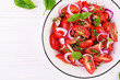 Tomato salad with basil and red onions. Homemade food.  Concept healthy meal. Vegan cuisine. Top view