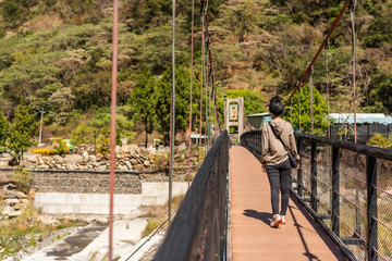 Sticker - woman walk on a suspension bridge