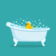 Retro bathtub with a rubber yellow duckling toy in the foam.