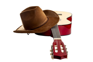 Fototapete - American culture, folk song and country muisc concept theme with a cowboy hat and an acoustic guitar isolated on white background with a clip path cut out
