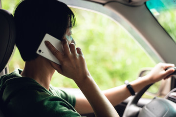 woman talking on cellphone when driving