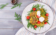 Zucchini pancakes with corn and sour cream served arugula, tomatoes salad. Top view