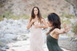 © Elena Ray - Two Wild Women dancing in desert wilderness nature.