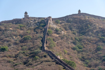 Wall Mural - The long wall on the mountain of Amber fort in historical city of Amer, Jaipur, Rajasthan, India