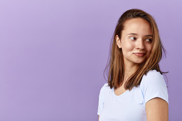 cunning cheerful beautiful girl looking away, close up portrait, copy space, woman making up a plan, idea