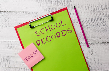 Word writing text School Records. Business photo showcasing Information that is kept about a child at school Biography Metal clipboard paper sheets marker sticky notes pad wooden background