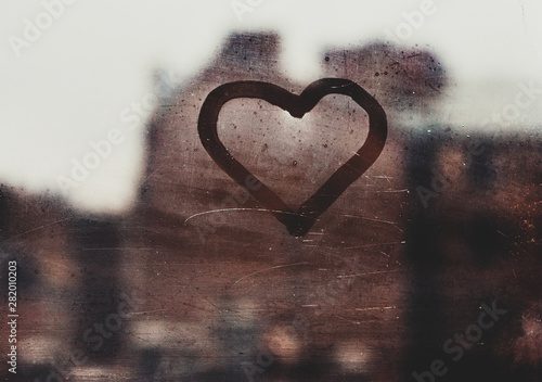 love concept, heart silhouette on a window glass