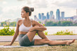 © Maridav - Yoga stretch exercise fit Asian woman stretching lower back for spine health on city outdoor fitness class in park. Seated spinal twist.