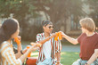 © zinkevych - Two students clanging their pop cans during picnic.
