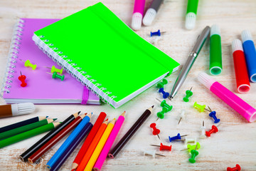 Items for the school on a wooden table.