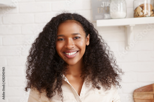 Happy Young Mixed Race Female Wearing Beige Shirt Looking At